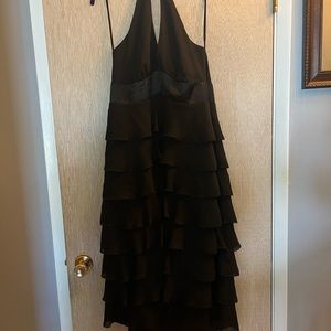 Woman’s halter style black flouncy party dress.